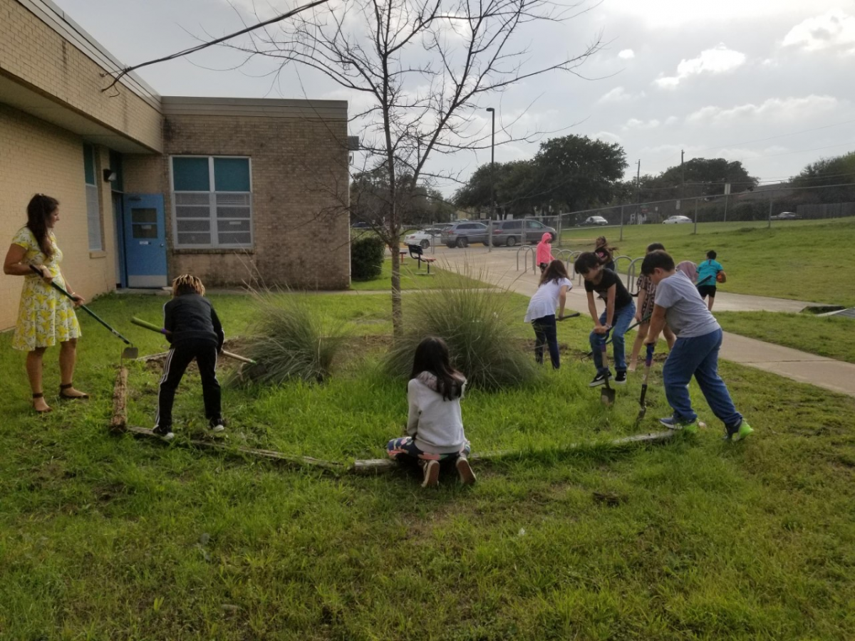 Students cleaning up the school in the ACE after school program